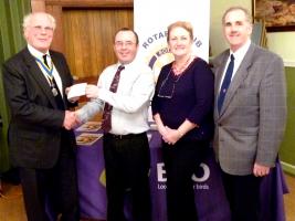 President John presents Paul Stancliffe with a Cheque to enable the Project to continue, over looked by Linda Butler, and Husband, Stephen.